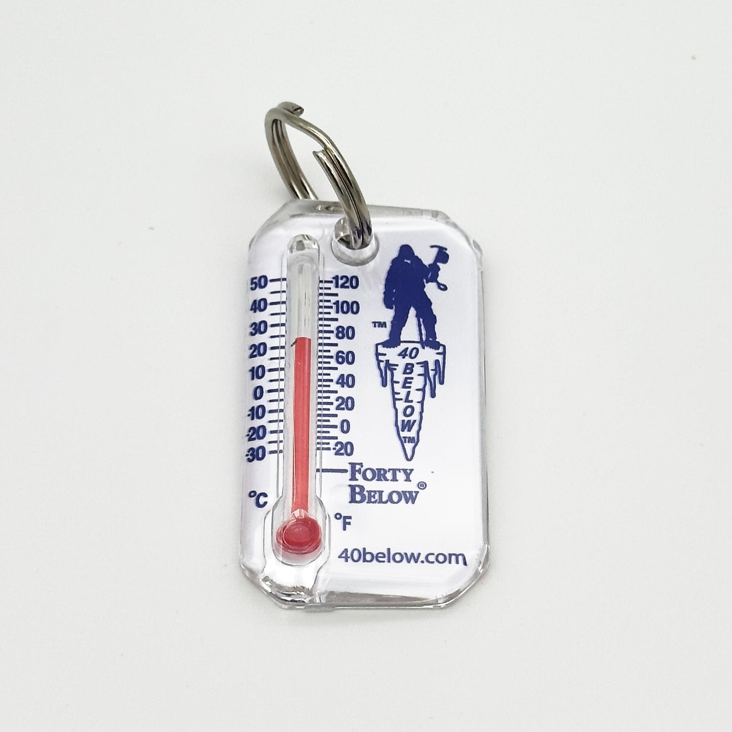 Forty Below Thermometer white with blue text and red thermometer gauge flat on white surface