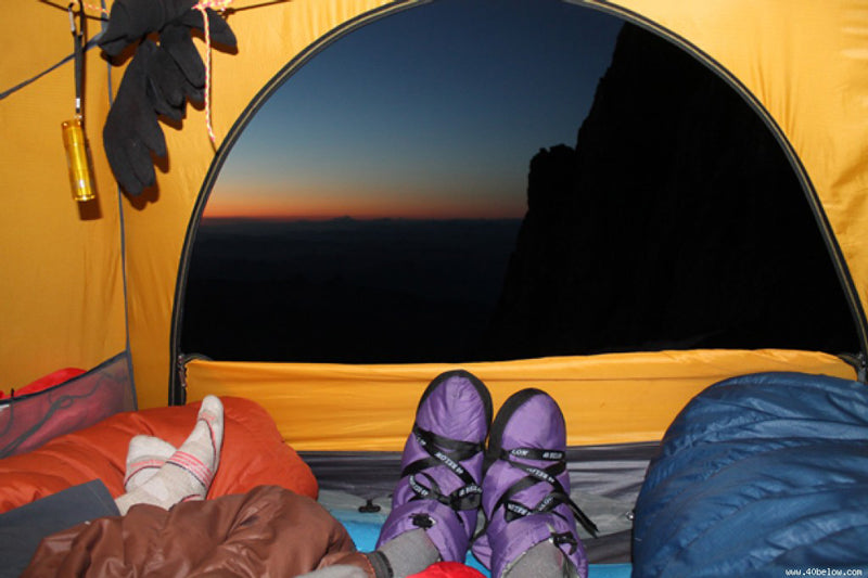 Forty Below Insulated Camp Booties in a tent looking at a sunset