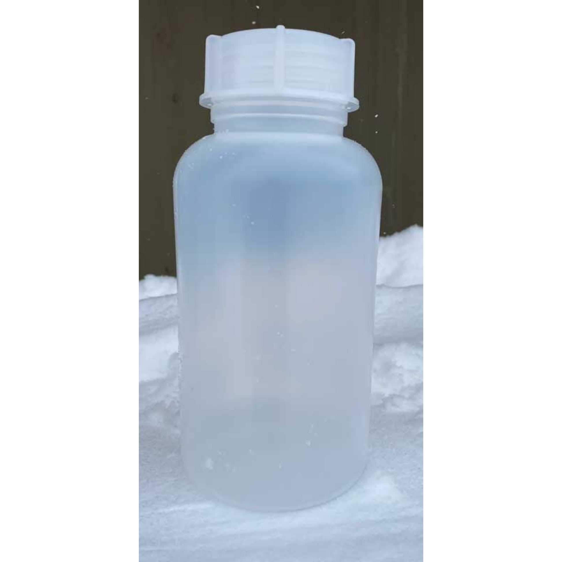 Single side profile of Forty Below Cold Weather plastic water bottle with white lids on a snowy background