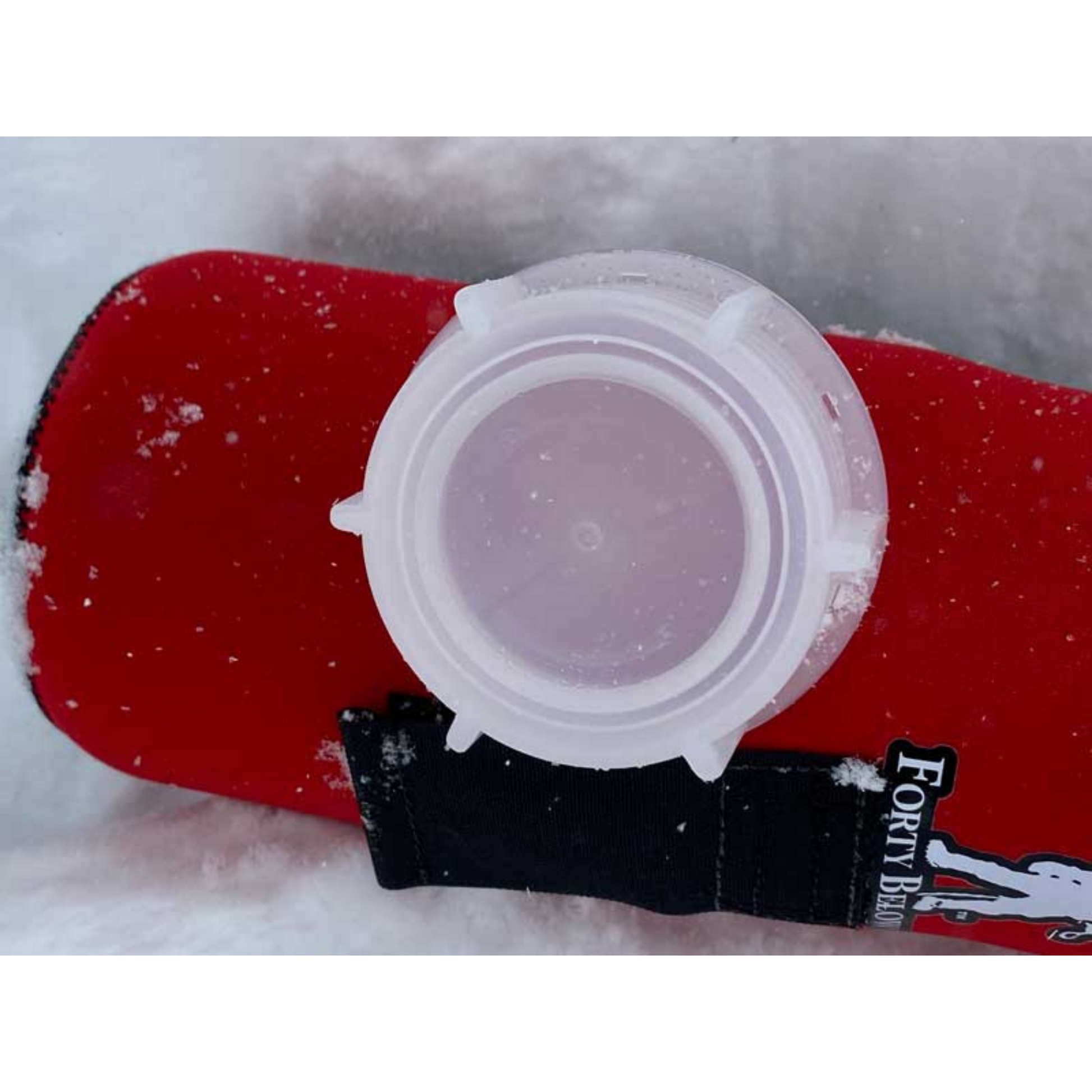 Forty Below Cold Weather water bottle lid next to Red Forty Below Bottle Cover