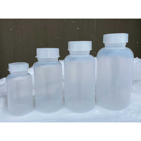 Set of four clear Forty Below Cold Weather plastic water bottles with white lids on a snowy background