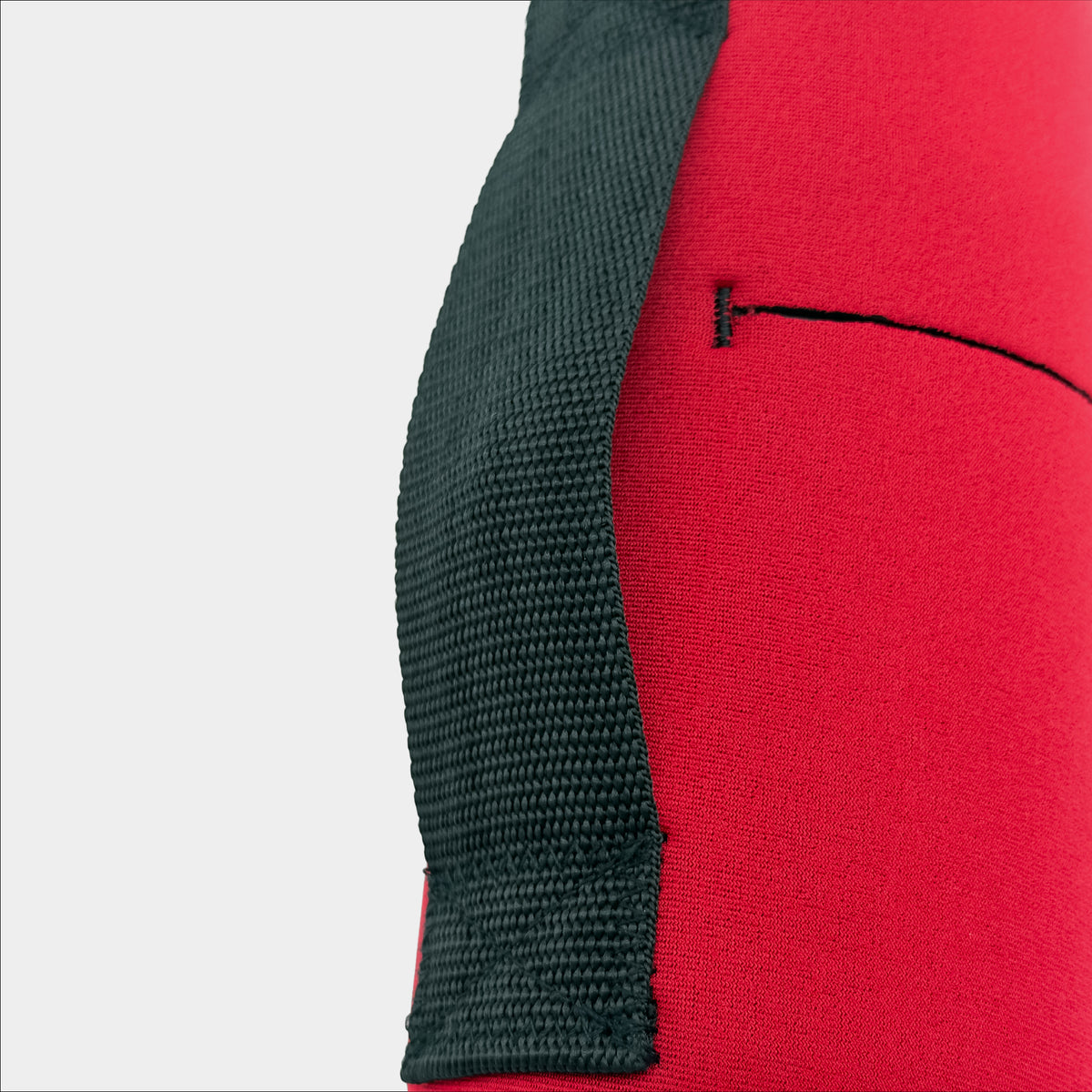 Forty Below 1.0 Liter Insulated Bottle Cover in Red close up rear view showing black webbing hip belt on a gray background