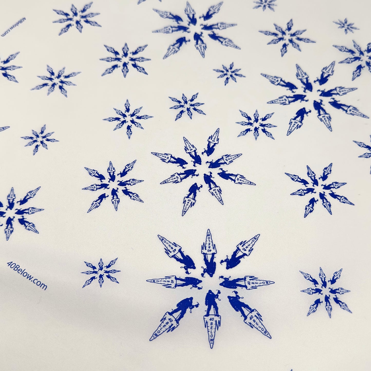 Forty Below Synthetic Bandana white with blue pattern of snowflakes made from the 40 below icicle logo