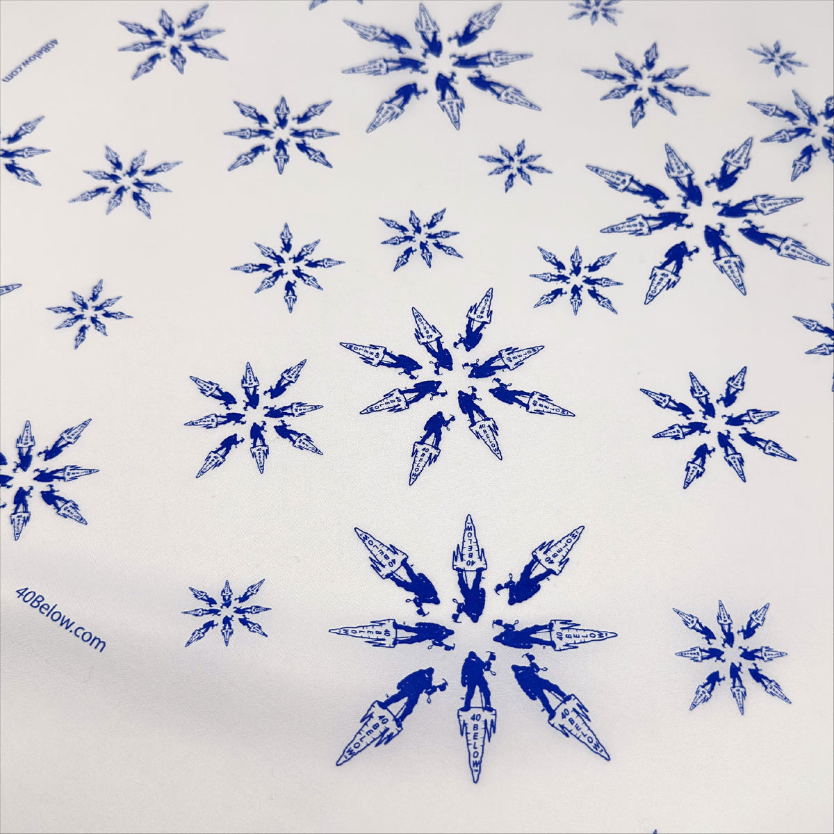 Forty Below Synthetic Bandana white with blue pattern of snowflakes made from the 40 below icicle logo
