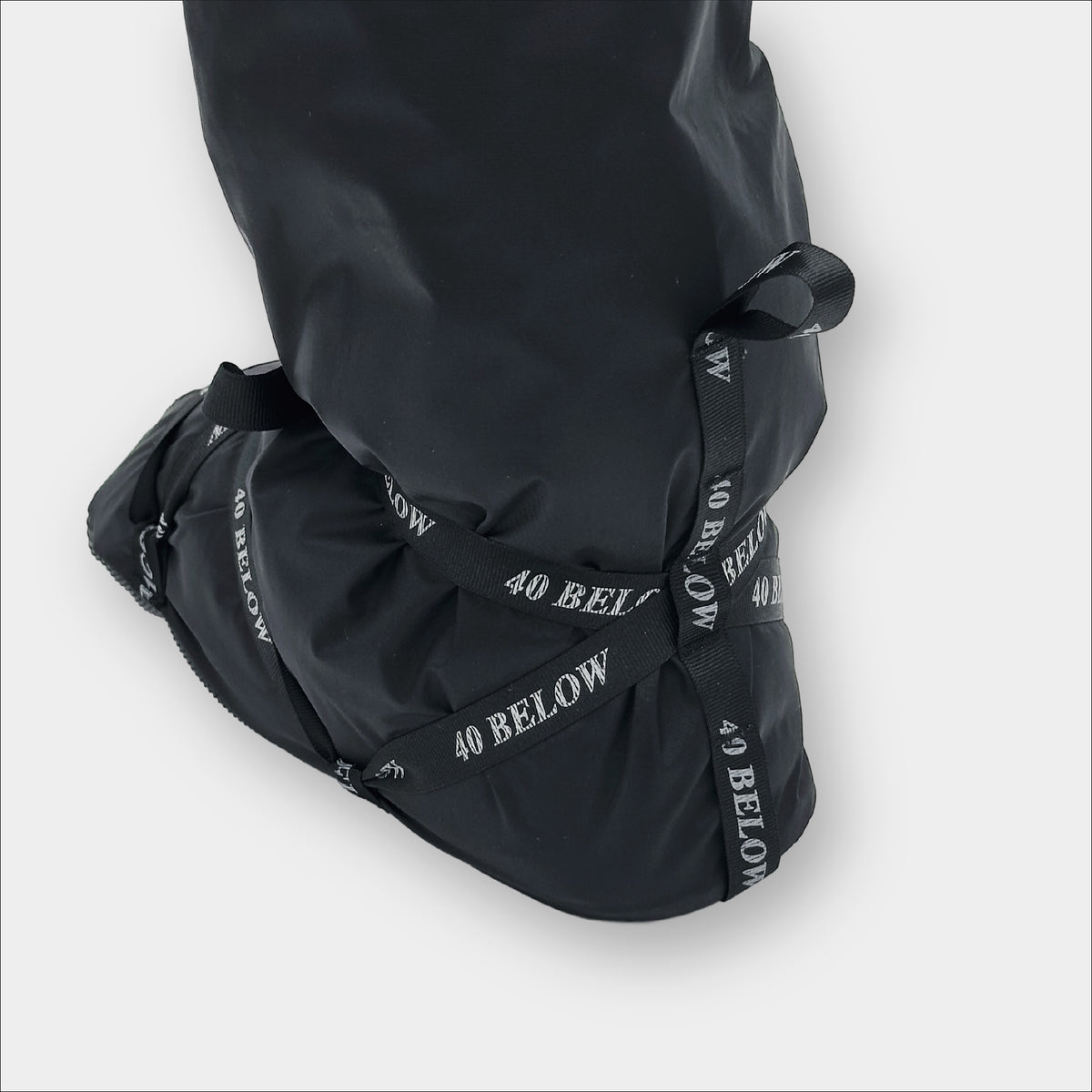 Forty Below Camp Bootie Overbootie cover rear view showing heel and black and white lacing  with white 