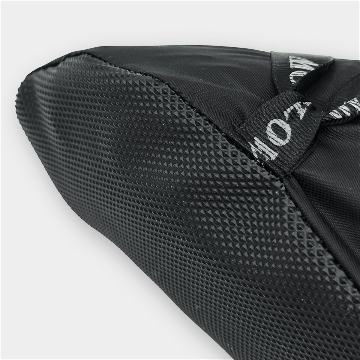 Forty Below Camp Bootie Overbootie close up on toe grippy sole material with white background
