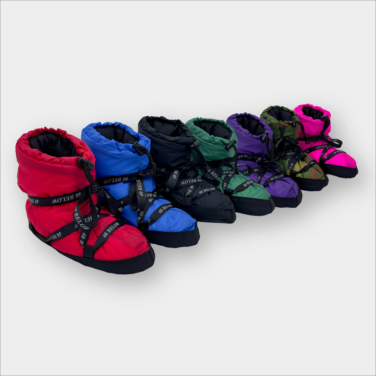 Forty Below Insulated Camp Bootie red, blue, black, green, purple, camo, and pink colors next to eachother with black ribbon lacing on a grey backdrop