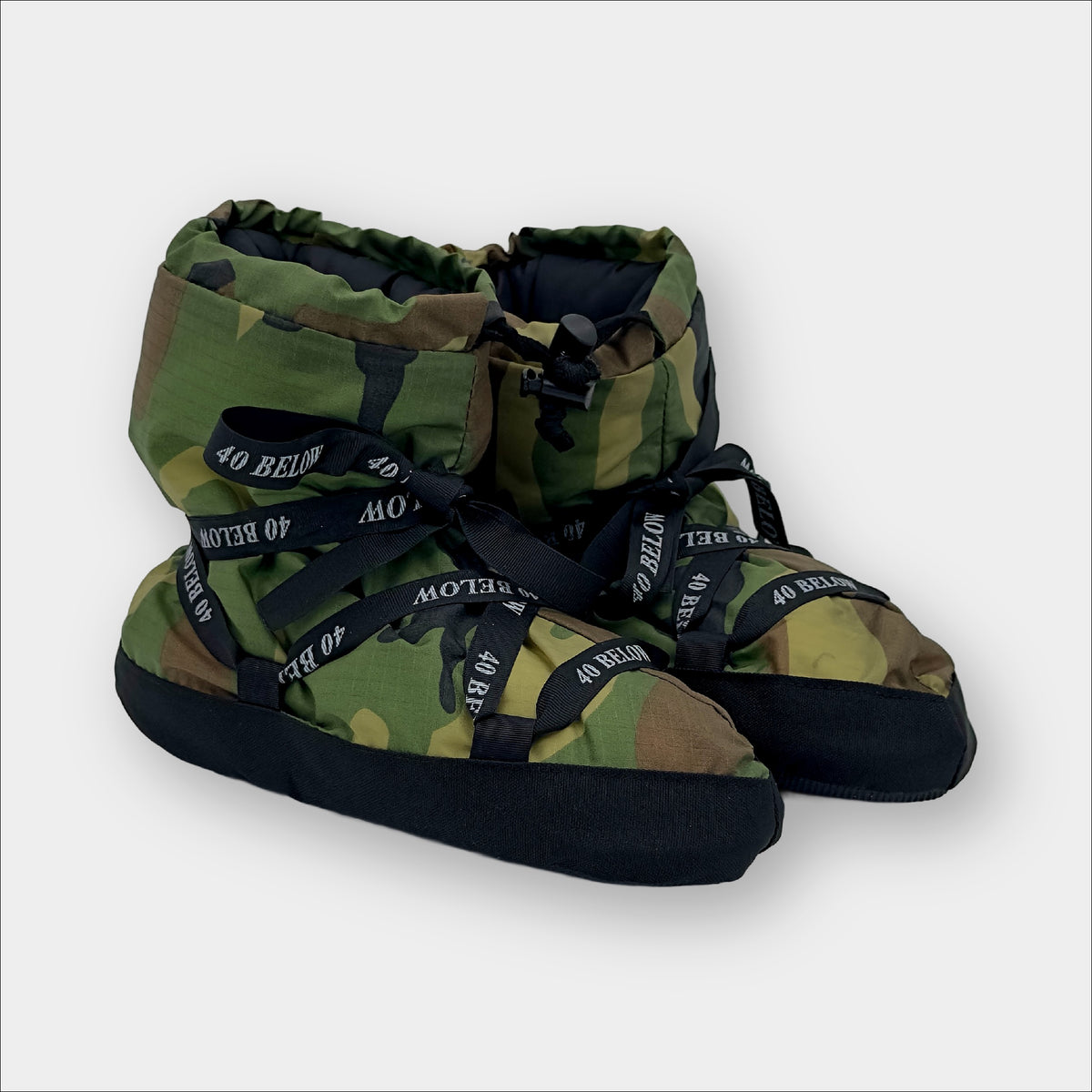 Forty Below Insulated Camp Bootie Side Thumbnail woodland camo with black ribbon lacing on a grey background