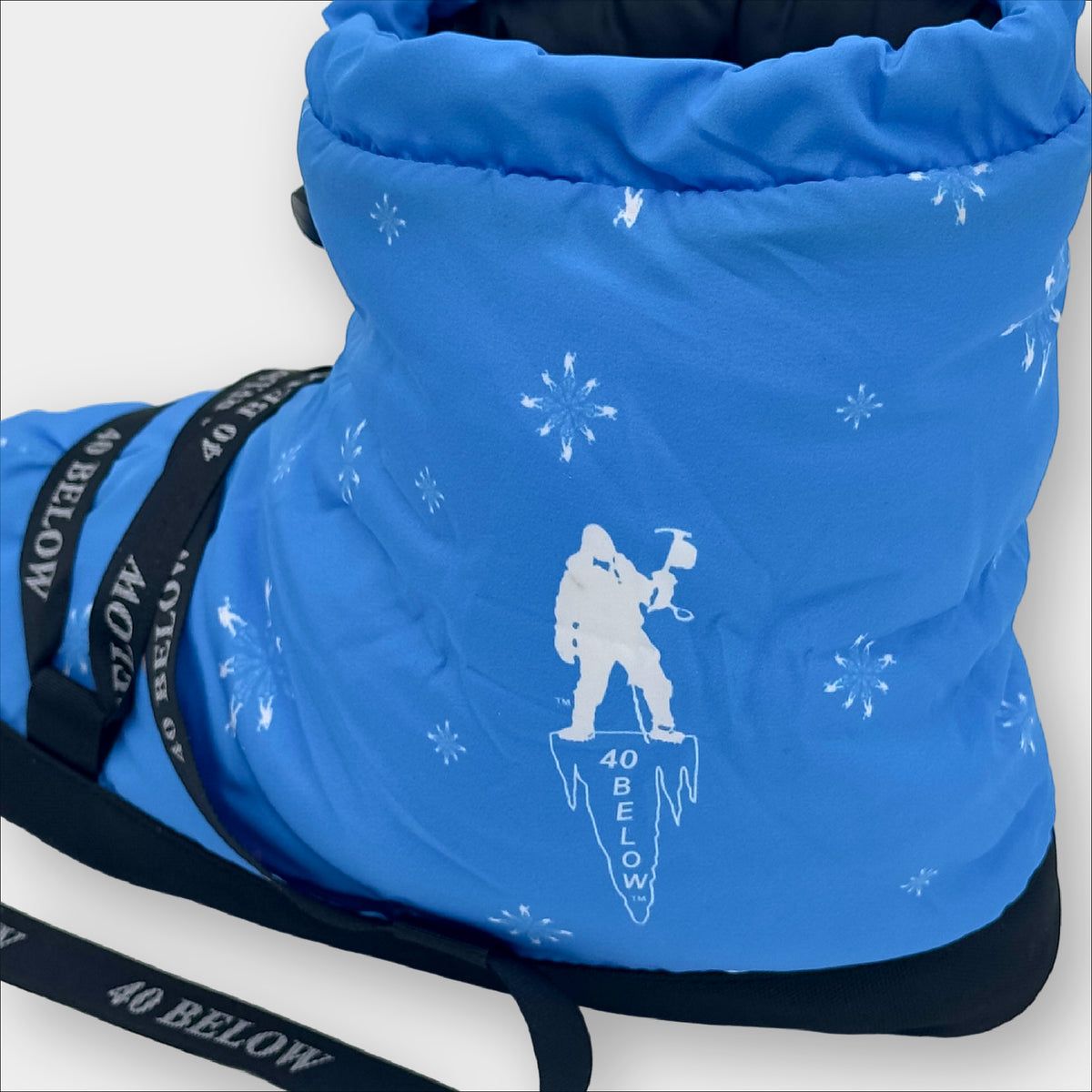 forty below insulated camp bootie snowflake blue pattern rear side view showing pattern graphic with black lacing on a grey background