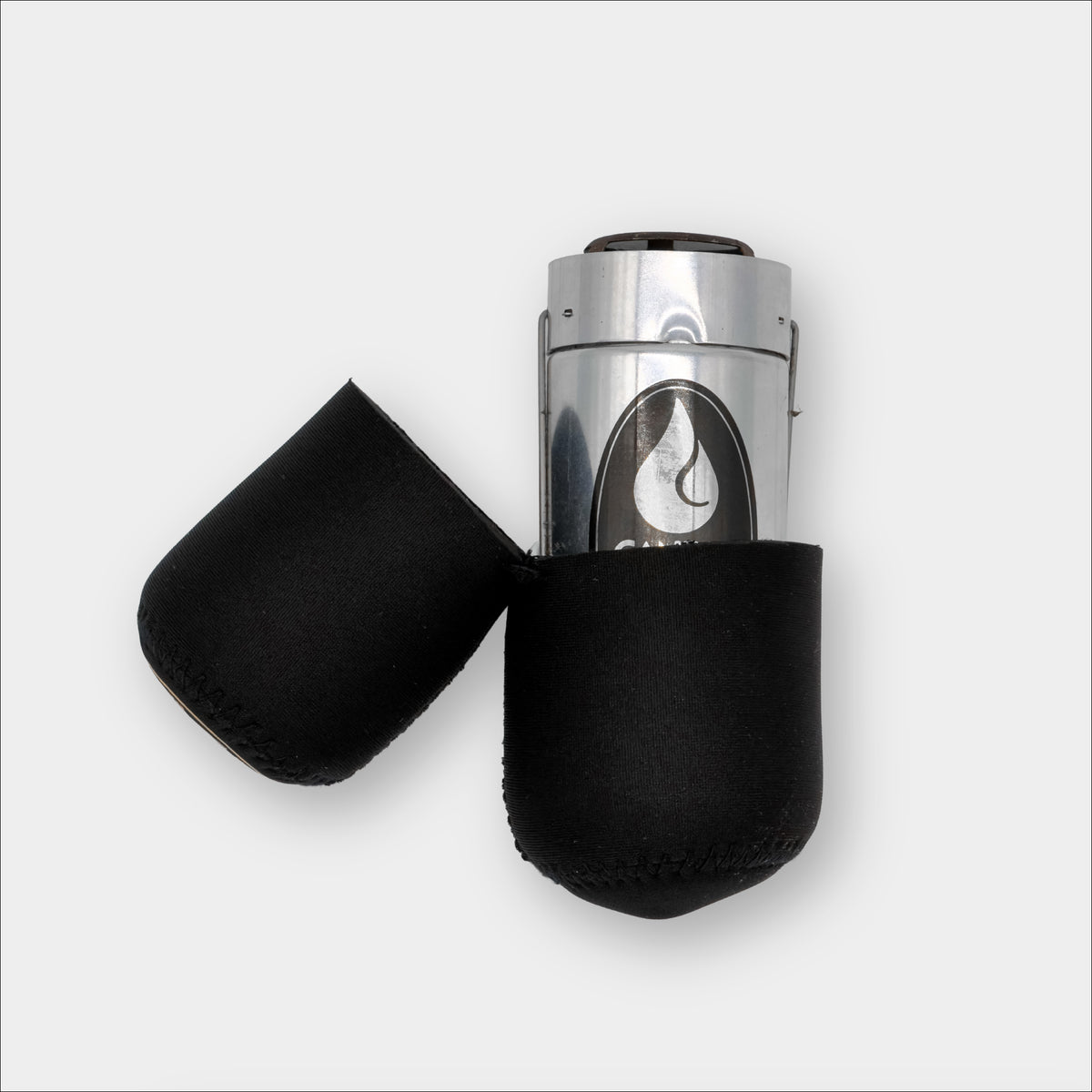 Forty Below Insulated lantern capsule black side view partially open with a lantern on the inside on a plain grey background