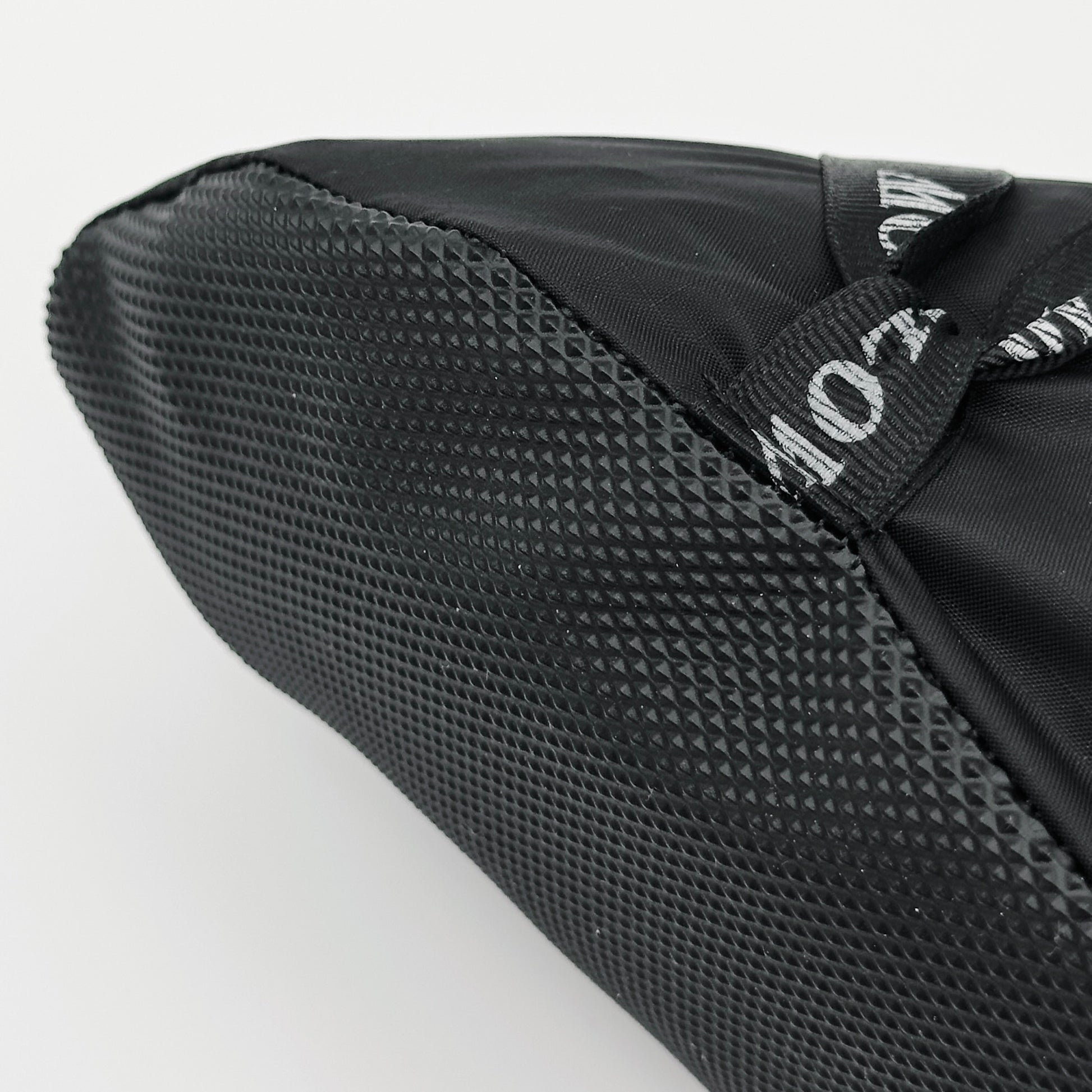 Forty Below Camp Bootie Overbootie close up on toe grippy sole material with white background