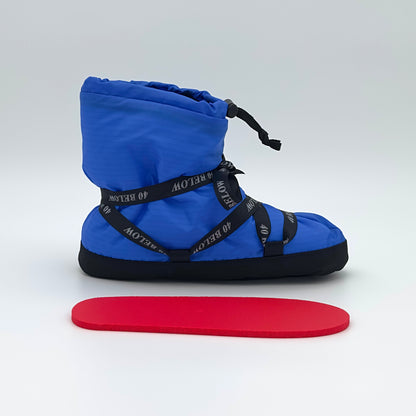 Forty Below Insulated Camp Bootie side profile, blue with black lacing, with a red foam insole below it on a white background