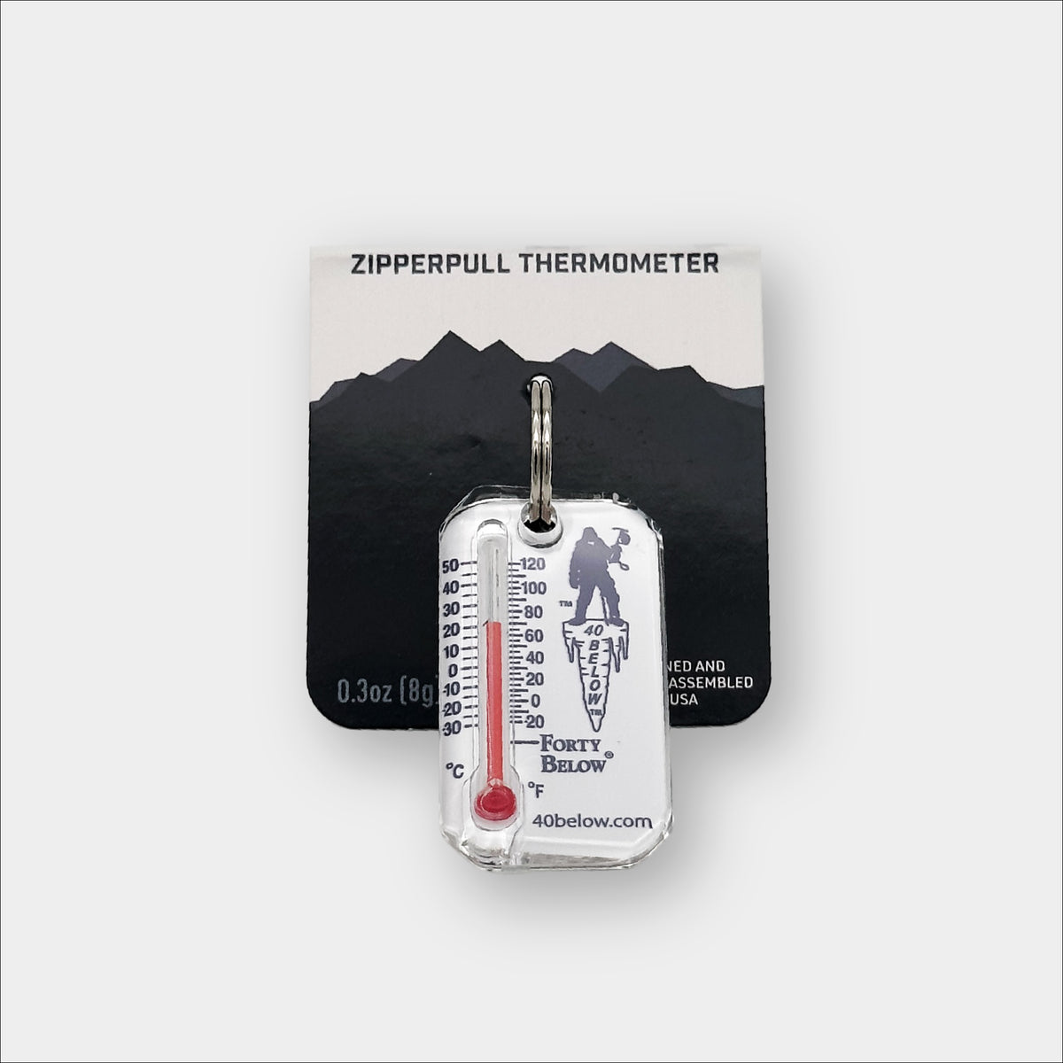 Forty Below Thermometer white with blue text and red thermometer gauge with part of the packaging behind it