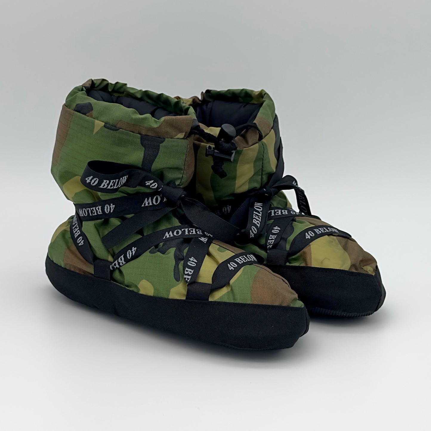 Forty Below  insulated camp bootie thumbnail woodland camo pattern with black lacing on a white background